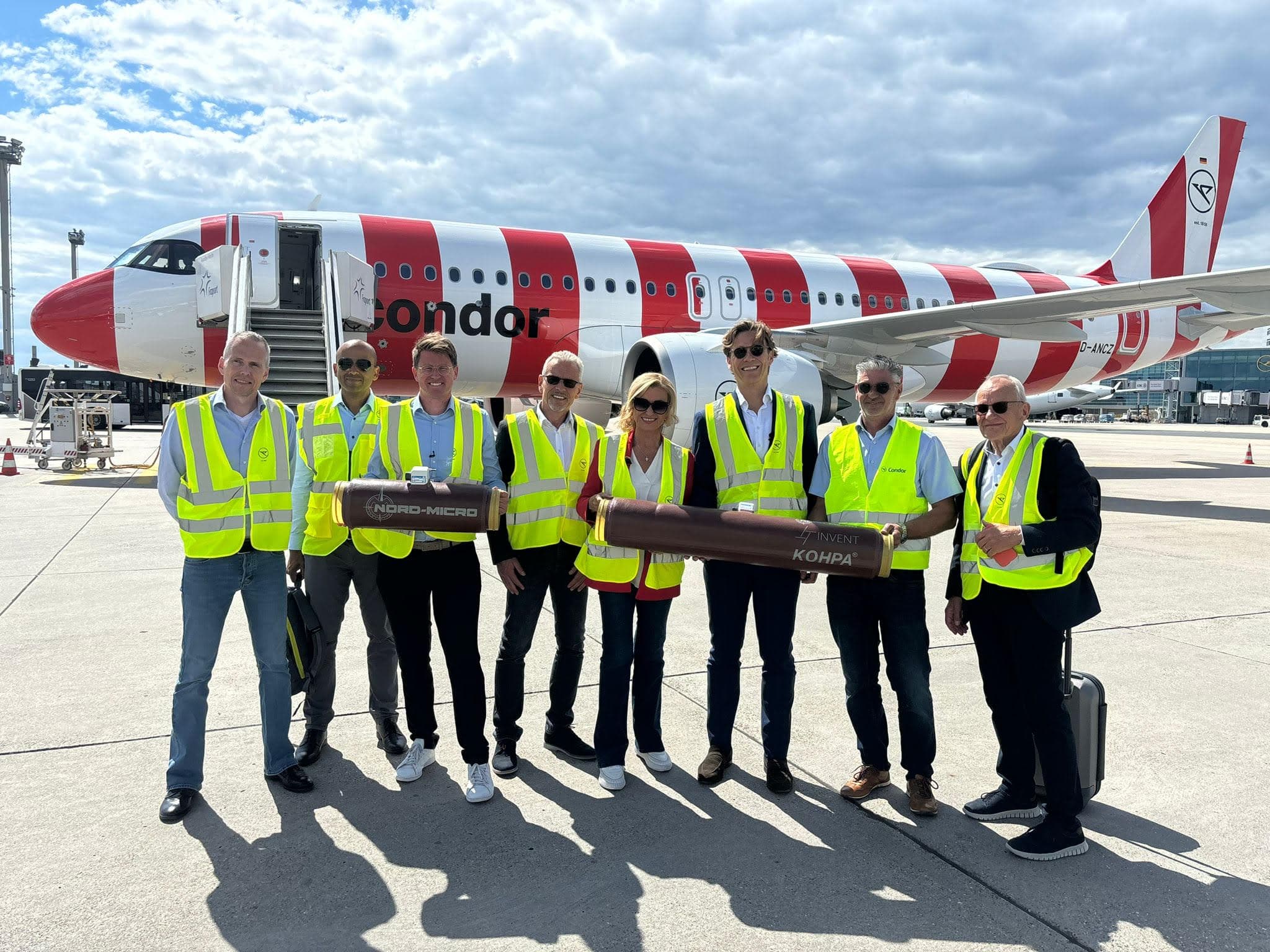 KOHPA® team at Frankfurt Airport with Condor Airbus — aviation partnership